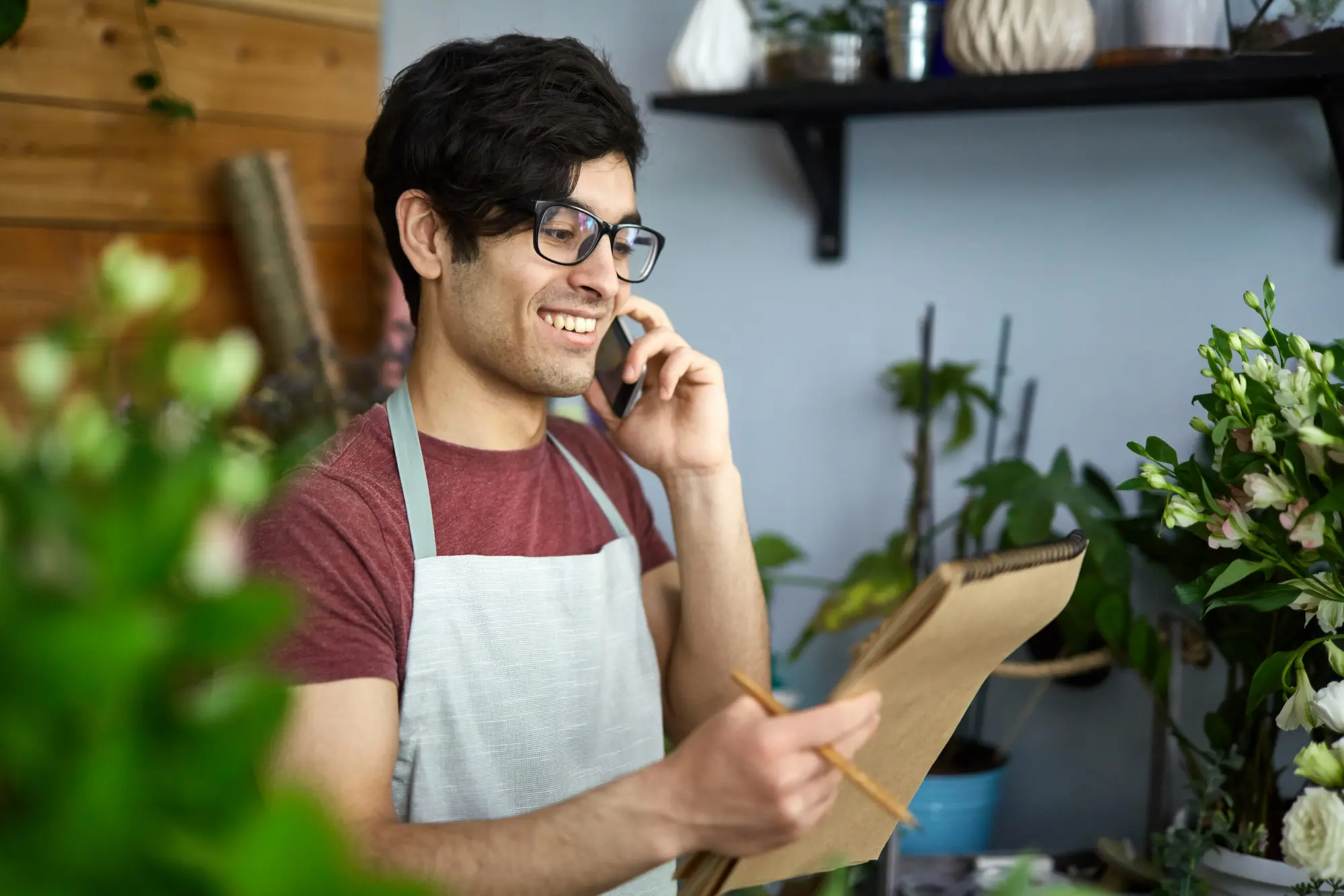 Smiling business owner on phone with ASuperior Contact Center support.